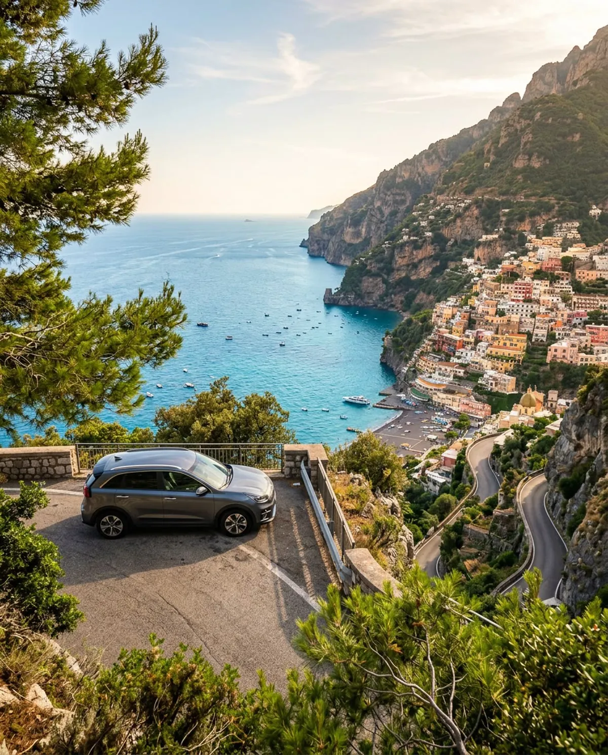 Dramatic sea cliffs and colorful hillside villas along the winding Amalfi coast road above the turquoise sea